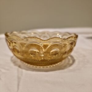 Vintage amber pressed glass bowl in the Bartlett Collins St. Genevieve pattern.
